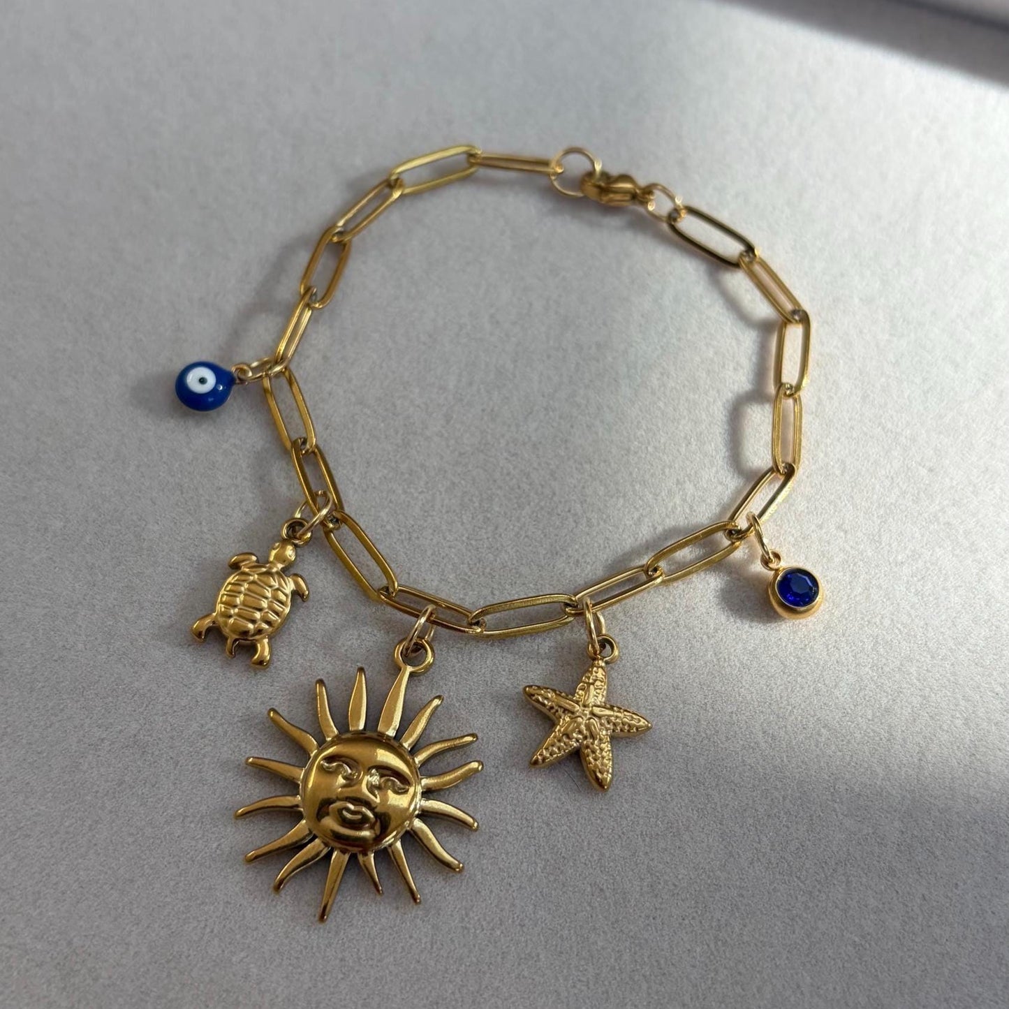 Gold Charm Bracelet with Sun, Seashells and Evil Eye Charms